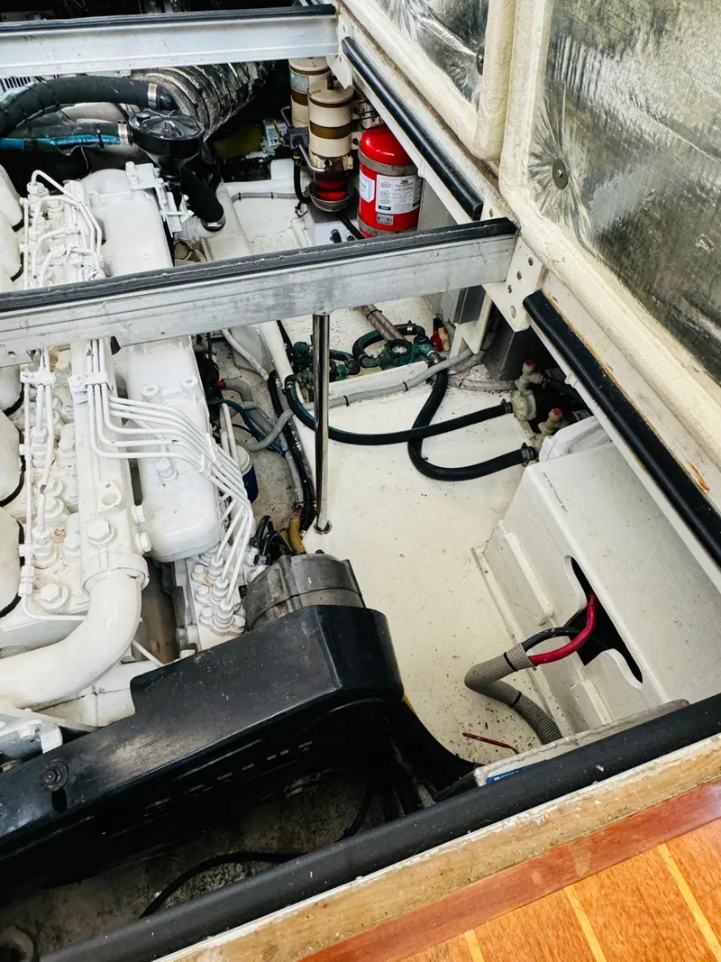 Slide: The Image of Engine compartment of 2000 Holland 38 Downeast Cruiser with visible components and fire extinguisher. - 45