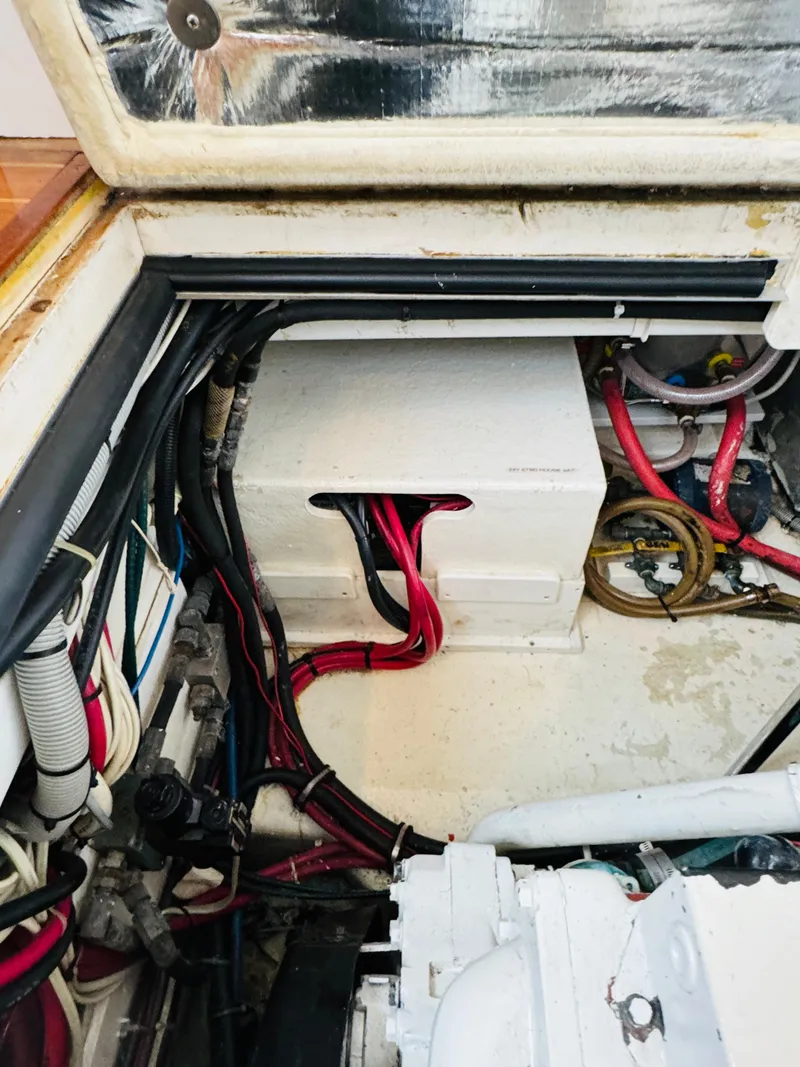 Slide: The Image of Engine compartment of 2000 Holland 38 Downeast Cruiser with visible wiring and components. - 48