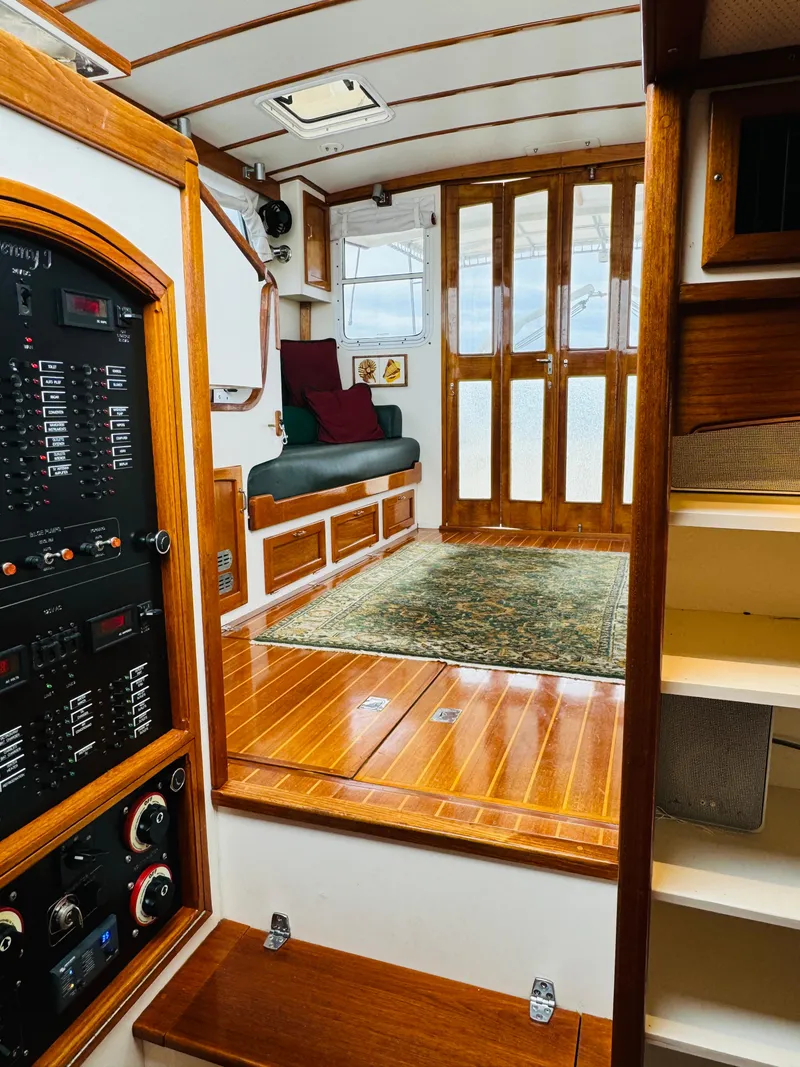 Slide: The Image of Interior of 2000 Holland 38 Downeast Cruiser with wood paneling and seating area. - 5