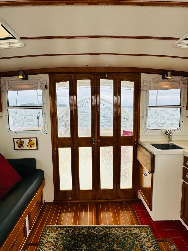 Slide: The Image of Interior of 2000 Holland 38 Downeast Cruiser with wooden doors and ocean view. - 6