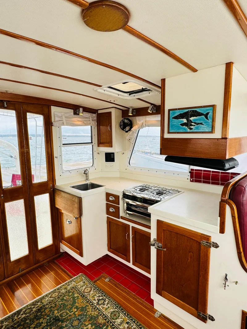Slide: The Image of Interior of 2000 Holland 38 Downeast Cruiser with wooden cabinetry and nautical decor. - 8