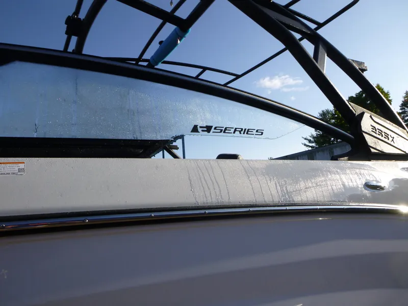 Slide: The Image of 2024 Yamaha Boats 255XE, sleek design with wet glass and metal accents. - 2
