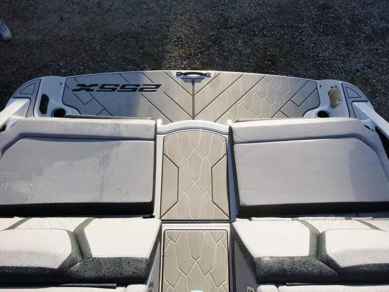 Slide: The Image of 2024 Yamaha Boats 255XE swim platform with cushioned seating and textured flooring. - 4
