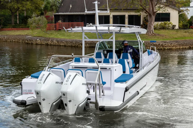 Slide: The Image of 2024 Axopar 37 Sun Top boat cruising on a calm waterway. - 4