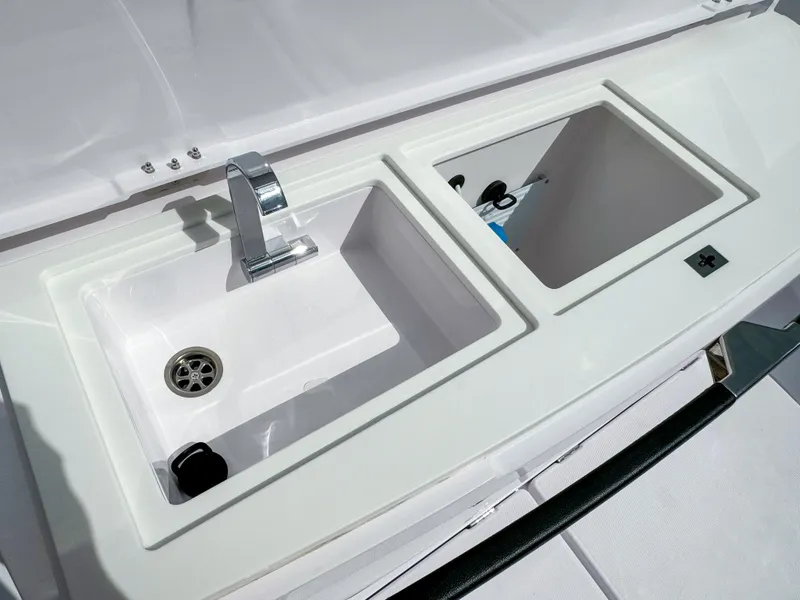 Slide: The Image of 2024 Axopar 37 Sun Top boat sink and storage compartment. - 7