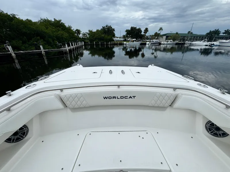 Slide: The Image of 2025 World Cat 280 CC-X boat docked in a serene marina setting. - 20