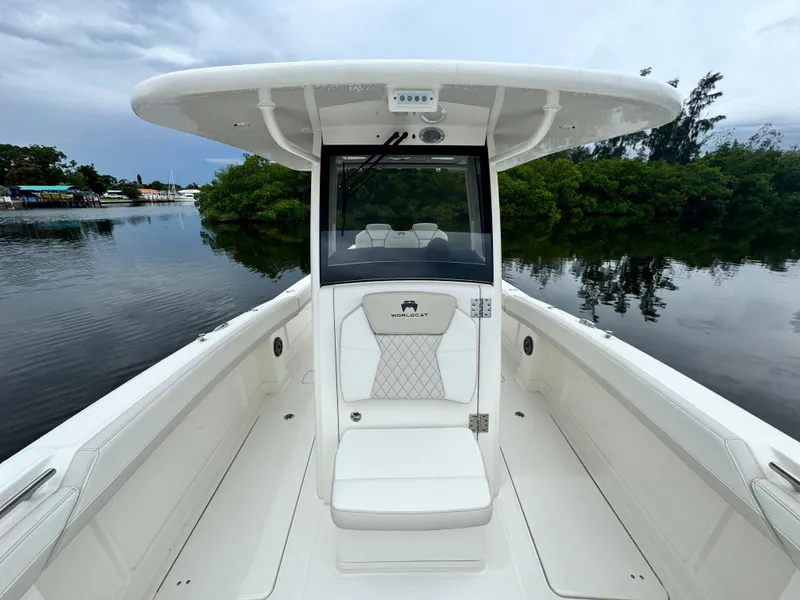 Slide: The Image of 2025 World Cat 280 CC-X boat, sleek design, white interior, calm water backdrop. - 21