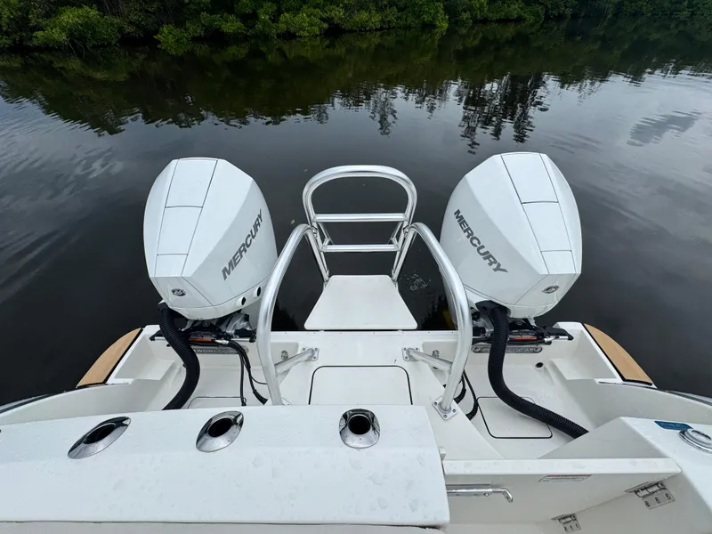 Slide: The Image of 2025 World Cat 280 CC-X boat with dual Mercury engines on a calm lake. - 6