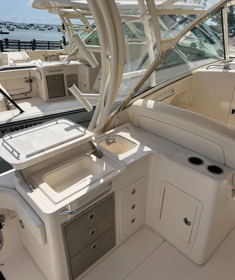 Slide: The Image of 2018 Grady-White Freedom 325 boat interior with sink and storage compartments. - 7