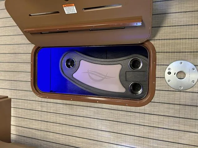 Slide: The Image of Storage compartment in 2025 SunCatcher Fusion 322C boat with blue LED lighting. - 11