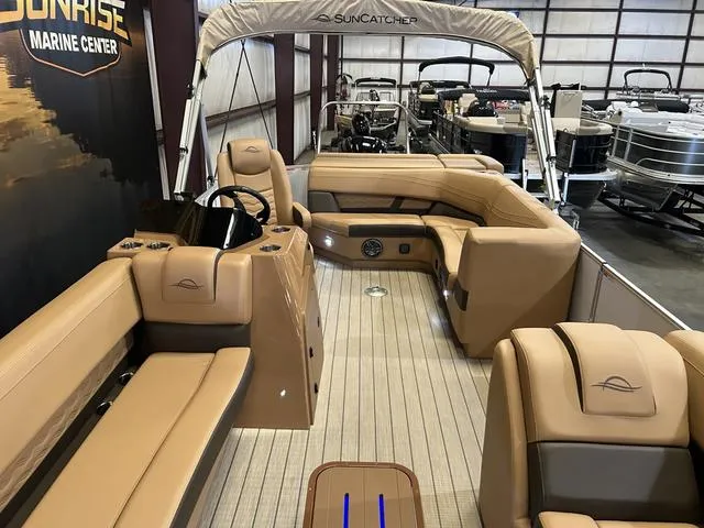 Slide: The Image of 2025 SunCatcher Fusion 322C boat interior with tan seating and modern design. - 8