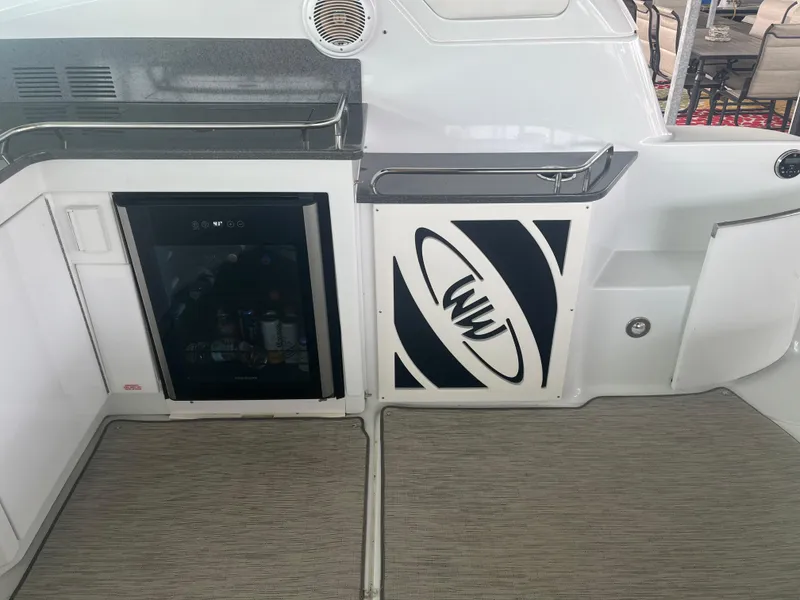 Slide: The Image of 2014 Formula 45 Yacht interior with mini fridge and storage compartment. - 27