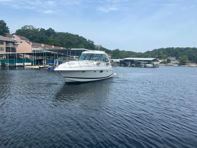 Slide: The Image of 2014 Formula 45 Yacht cruising on a serene lake near docks and trees. - 3
