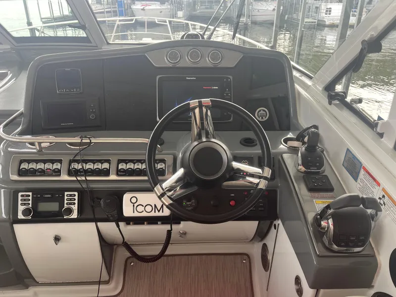 Slide: The Image of 2014 Formula 45 Yacht helm with advanced navigation controls and steering wheel. - 35