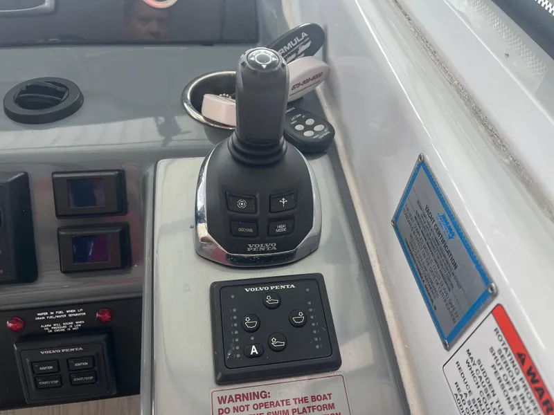 Slide: The Image of Control panel of a 2014 Formula 45 Yacht with joystick and warning labels. - 36