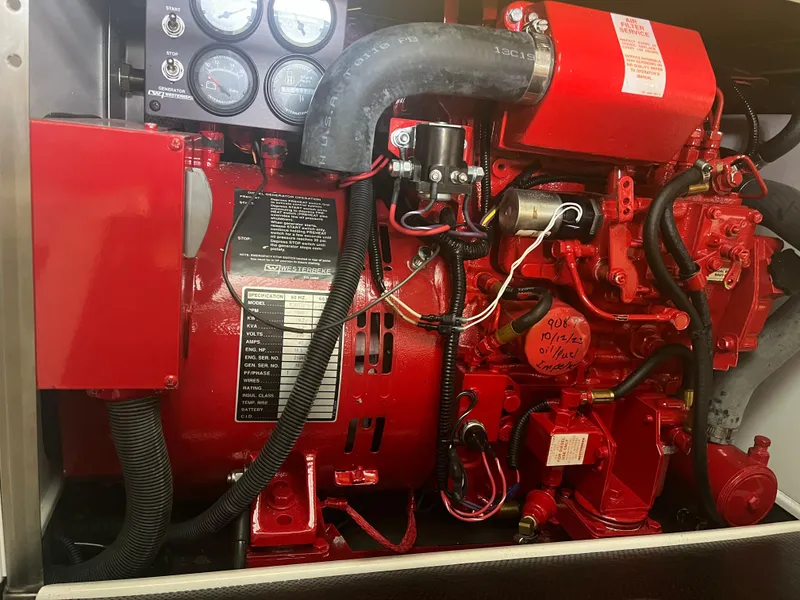Slide: The Image of Engine compartment of a 2014 Formula 45 Yacht, featuring red mechanical components. - 42