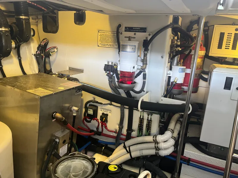 Slide: The Image of Engine room of 2014 Formula 45 Yacht with various mechanical components and wiring. - 43