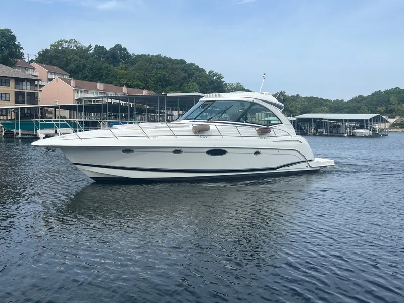Slide: The Image of 2014 Formula 45 Yacht cruising on a calm lake near docks. - 6