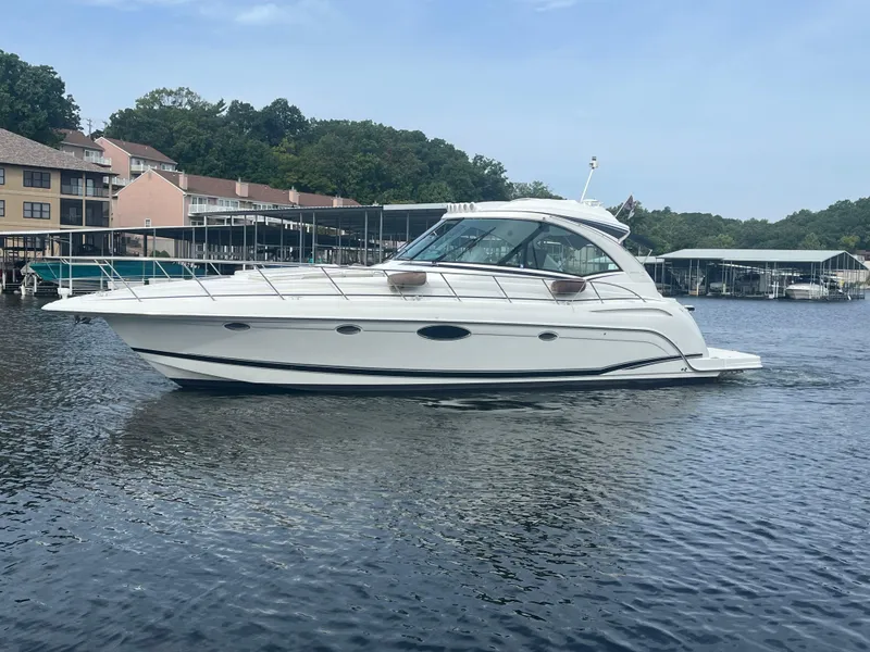 Slide: The Image of 2014 Formula 45 Yacht cruising on a serene lake near docks and trees. - 7