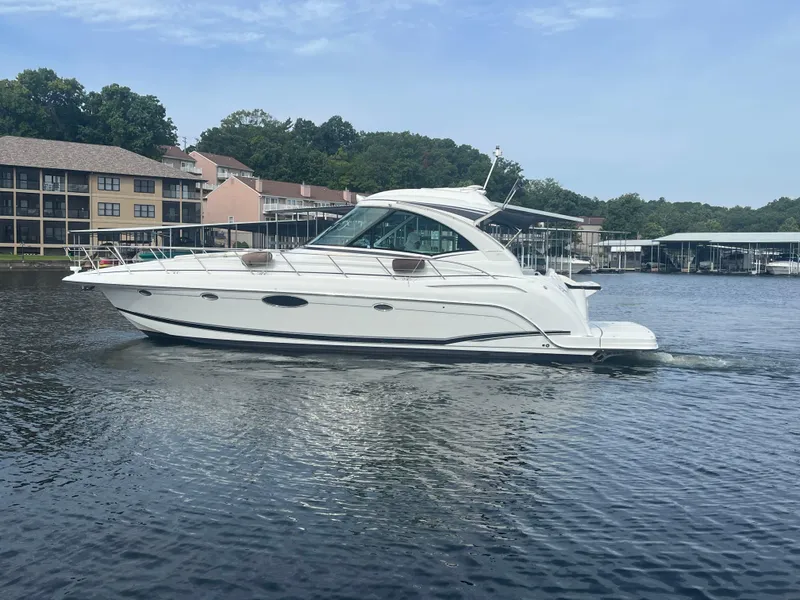 Slide: The Image of 2014 Formula 45 Yacht cruising on a calm lake near waterfront homes. - 8