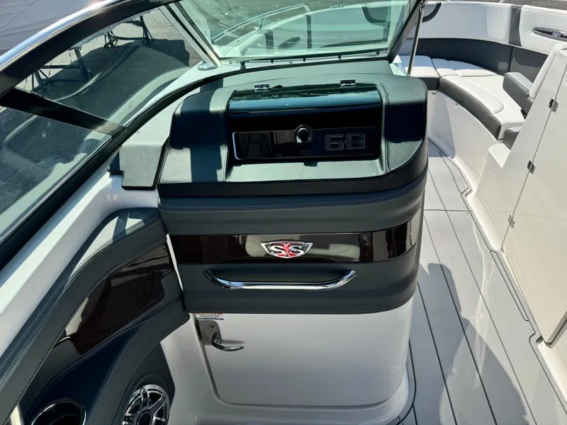 Slide: The Image of 2025 Chaparral 287 SSX boat interior with sleek dashboard and seating area. - 11