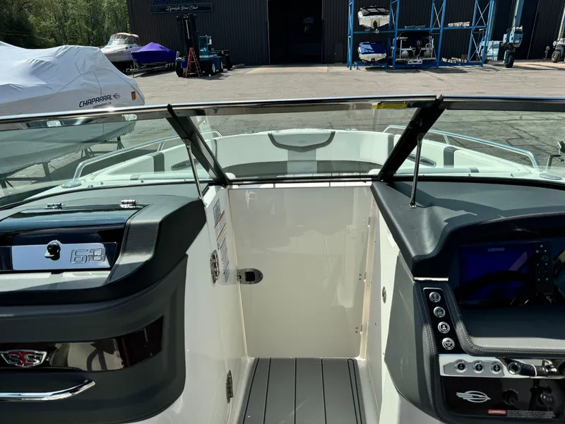 Slide: The Image of 2025 Chaparral 287 SSX boat interior with dashboard and open cockpit view. - 13