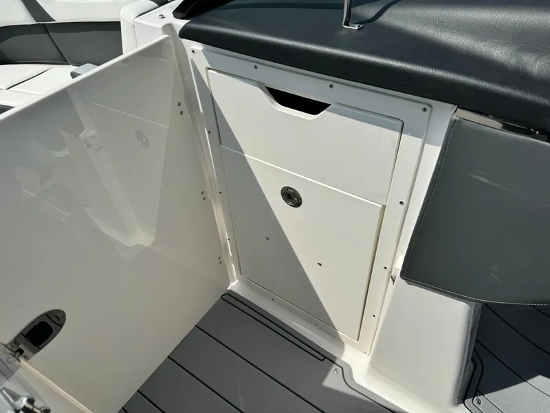 Slide: The Image of 2025 Chaparral 287 SSX boat interior storage compartment with sleek design and modern finish. - 14