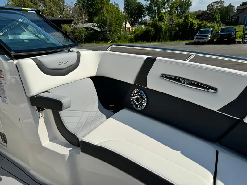 Slide: The Image of 2025 Chaparral 287 SSX boat interior with sleek white and black seating design. - 18