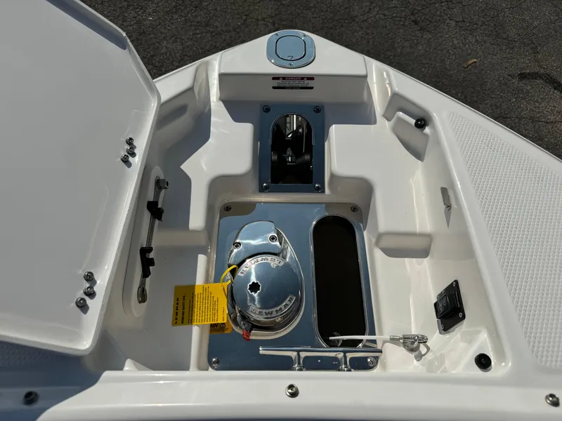 Slide: The Image of 2025 Chaparral 287 SSX boat anchor compartment with open hatch and visible hardware. - 21