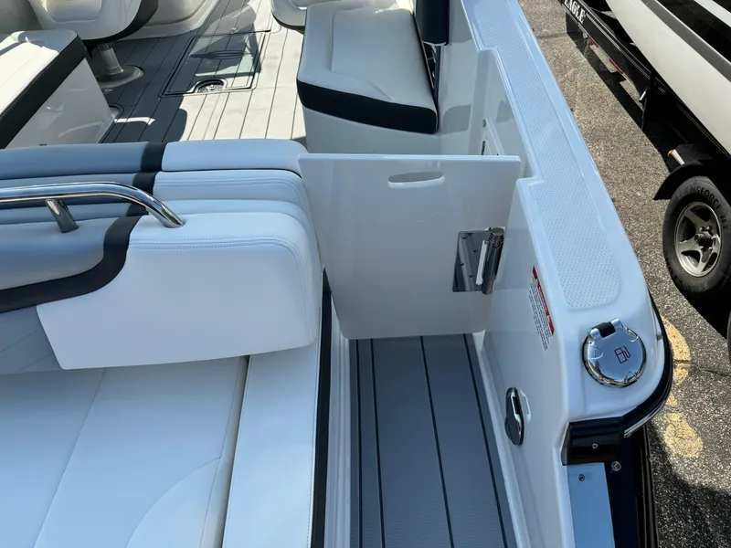 Slide: The Image of 2025 Chaparral 287 SSX boat interior with white seating and open side door. - 27