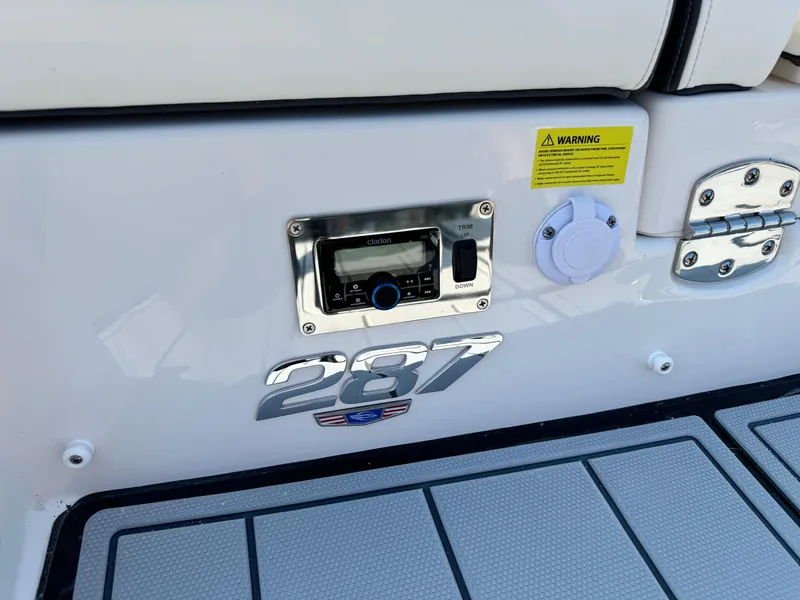 Slide: The Image of 2025 Chaparral 287 SSX boat dashboard with control panel and warning label. - 29