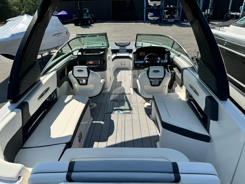 Slide: The Image of 2025 Chaparral 287 SSX boat interior with luxurious seating and modern dashboard. - 35