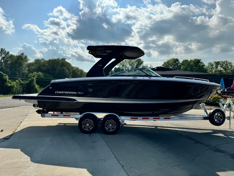 Slide: The Image of 2025 Chaparral 287 SSX boat on trailer under a partly cloudy sky. - 4