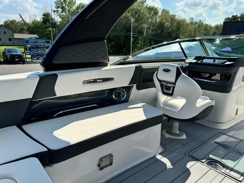 Slide: The Image of 2025 Chaparral 287 SSX boat interior with sleek seating and modern dashboard. - 40