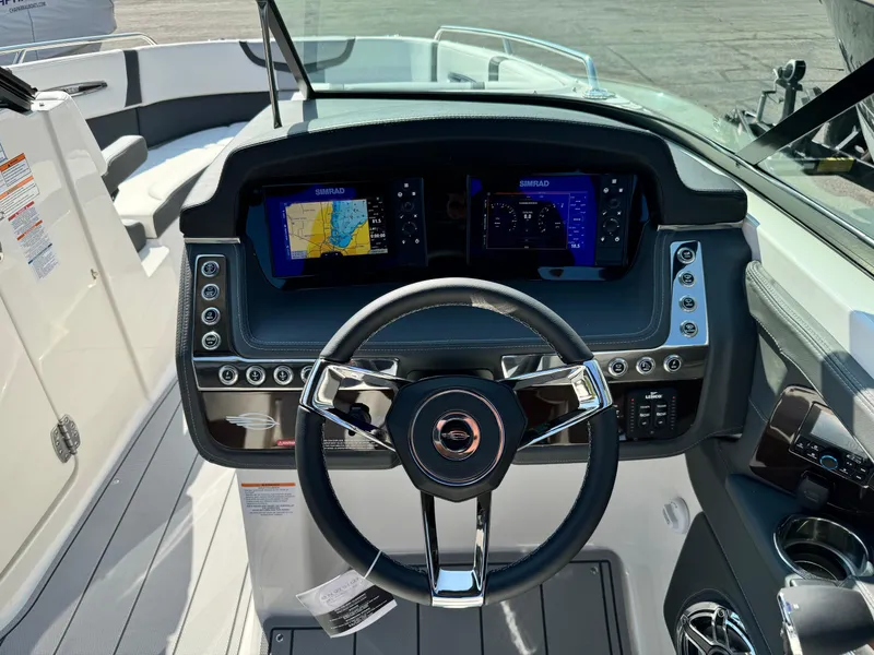 Slide: The Image of 2025 Chaparral 287 SSX boat dashboard with dual navigation screens and sleek steering wheel. - 42