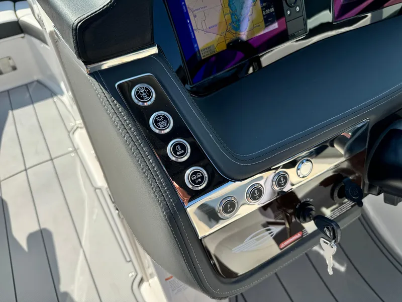 Slide: The Image of Control panel of 2025 Chaparral 287 SSX boat with navigation display and key ignition. - 43