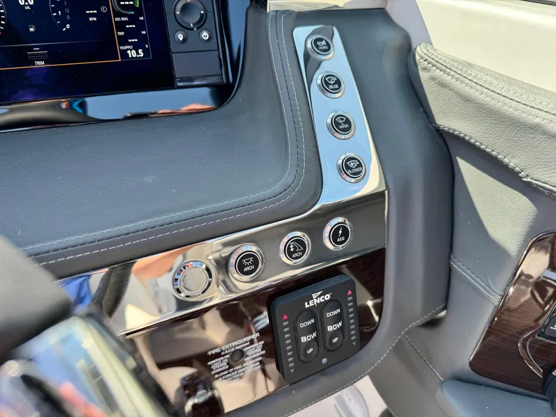 Slide: The Image of 2025 Chaparral 287 SSX dashboard with control panel and Lenco trim tab switches. - 44