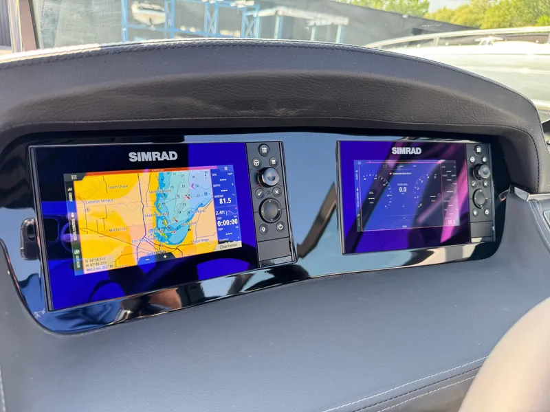 Slide: The Image of Dashboard of 2025 Chaparral 287 SSX with dual Simrad navigation displays. - 46