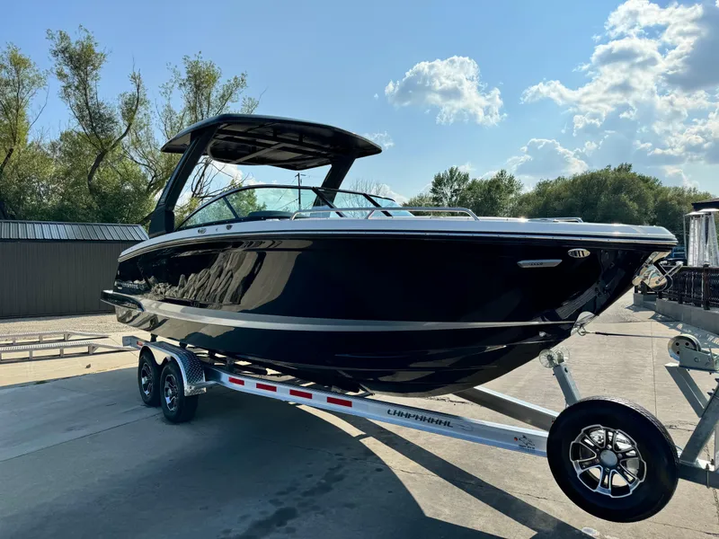 Slide: The Image of 2025 Chaparral 287 SSX boat on trailer, sleek black design, sunny day background. - 5