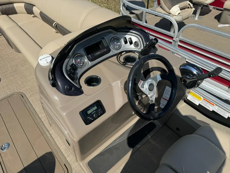 Slide: The Image of 2022 Sun Tracker SportFish 22 XP3 boat dashboard with steering wheel and gauges. - 10