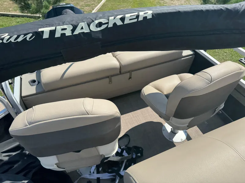 Slide: The Image of 2022 Sun Tracker SportFish 22 XP3 boat interior with beige seating and Sun Tracker branding. - 13