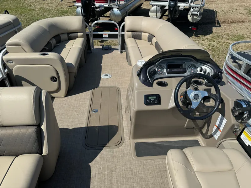 Slide: The Image of 2022 Sun Tracker SportFish 22 XP3 pontoon boat interior with beige seating and steering console. - 17