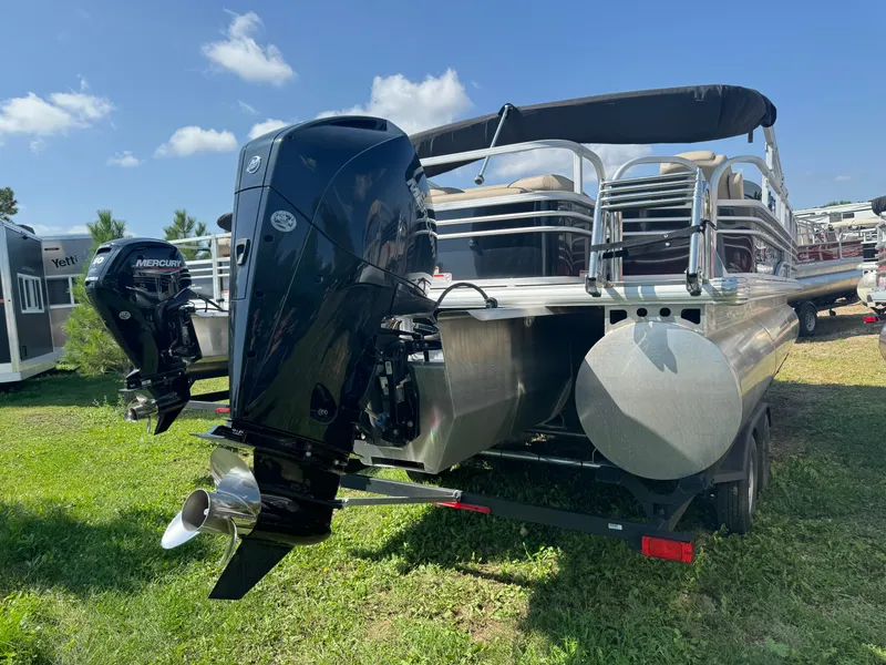 Slide: The Image of 2022 Sun Tracker SportFish 22 XP3 pontoon boat with dual outboard motors on grass. - 4