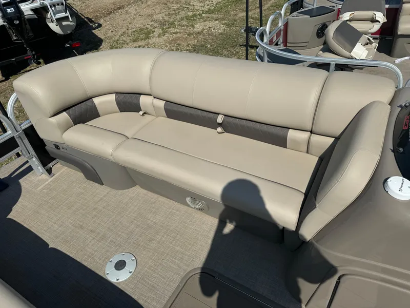 Slide: The Image of 2022 Sun Tracker SportFish 22 XP3 boat interior with beige seating and carpeted floor. - 7