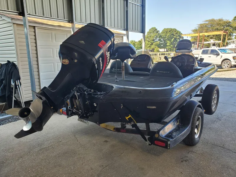Slide: The Image of 2003 Ranger 185 VX/VS boat with outboard motor in a garage setting. - 1