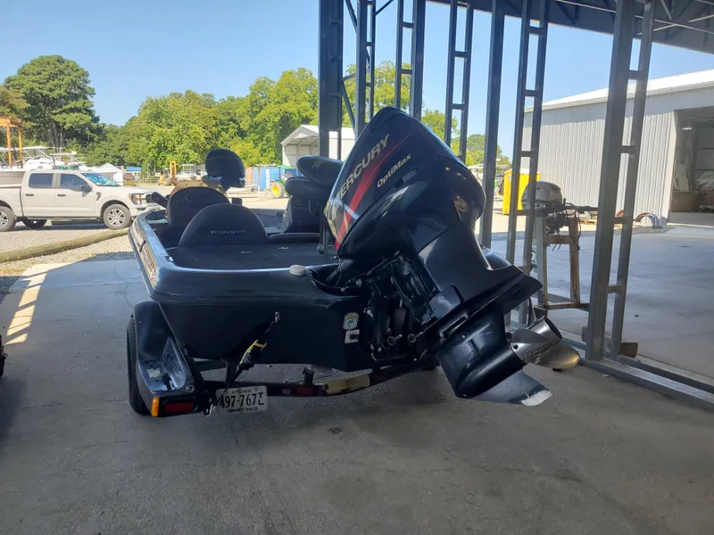 Slide: The Image of 2003 Ranger 185 VX/VS boat with Mercury outboard motor in a storage area. - 4