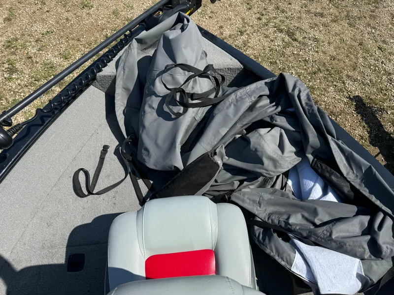 Slide: The Image of 2013 Tracker Pro Guide V-175 Combo boat interior with gray cover and seat. - 13