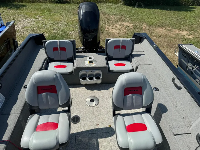 Slide: The Image of 2013 Tracker Pro Guide V-175 Combo boat interior with four gray and red seats. - 14