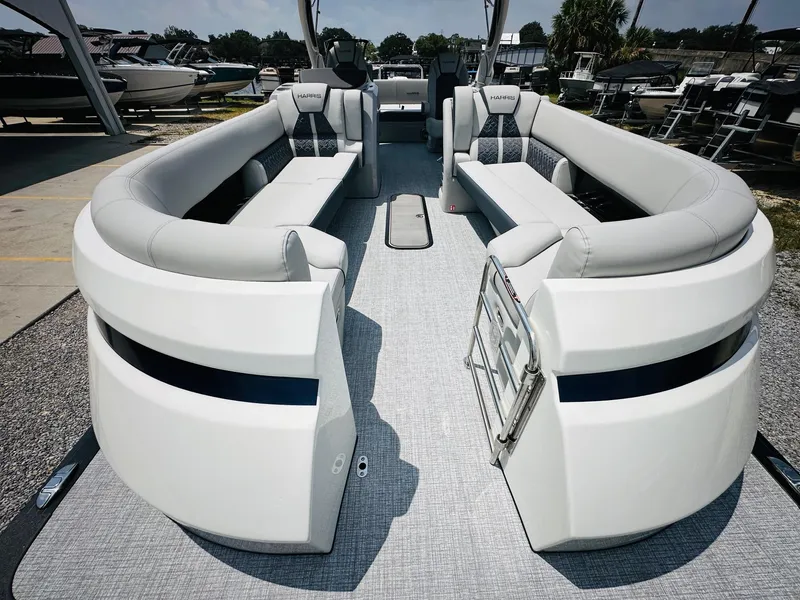 Slide: The Image of 2025 Harris Grand Mariner 250 pontoon boat with spacious seating and modern design. - 12