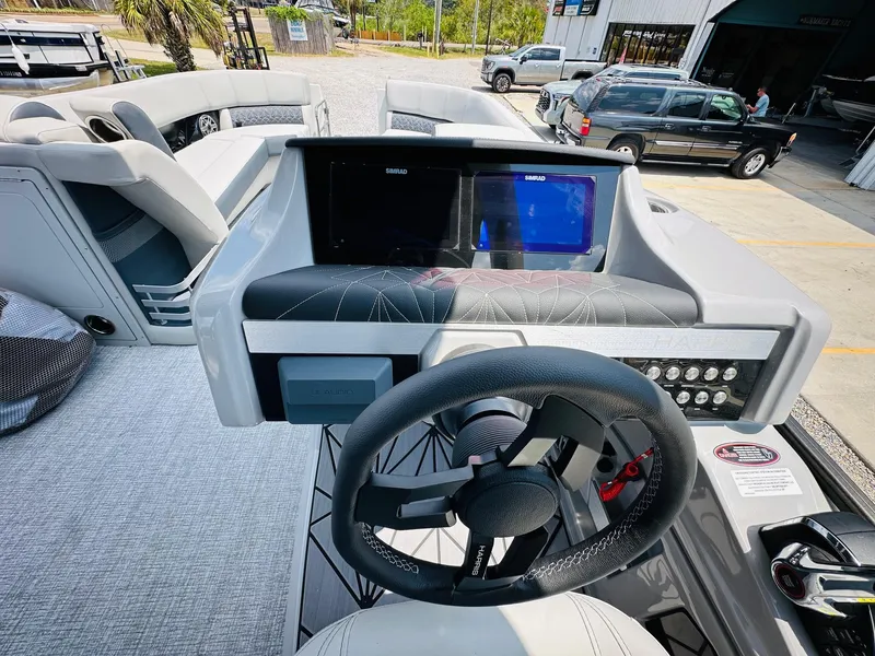 Slide: The Image of 2025 Harris Grand Mariner 250 helm with dual screens and modern steering wheel. - 17